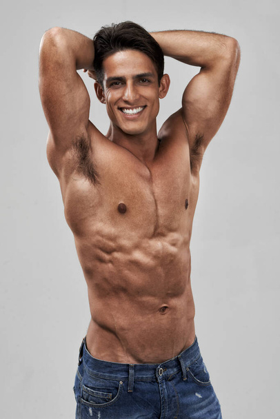 Working out pays off. A handsome young man smiling at the camera - Foto, immagini