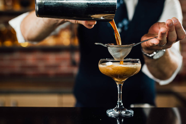 close up of barman preparing espresso martini cocktail - 写真・画像