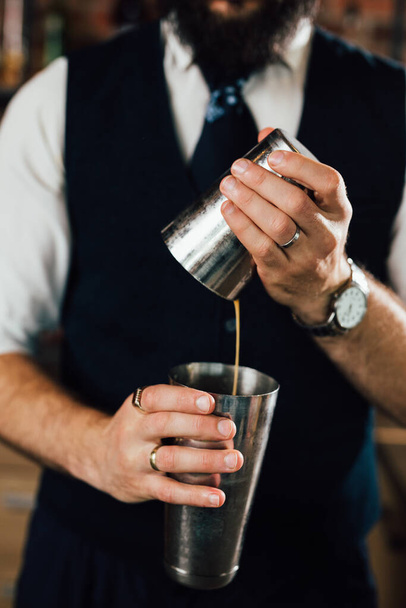 close up of barman holding shaker - Fotó, kép