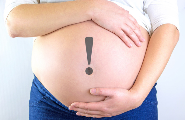 Pregnant woman belly with exclamation mark - Photo, Image