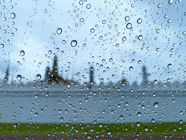 Enfoque selectivo en la gota de agua en el vidrio del coche cuando llueve en la temporada de monzones con fondo borroso. - Foto, imagen