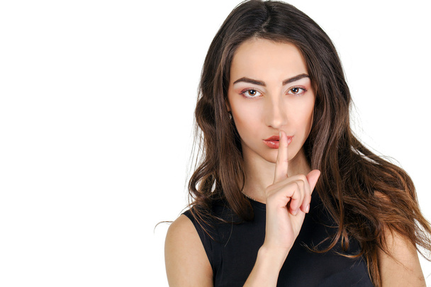 Woman has put forefinger to lips as sign of silence - Фото, зображення