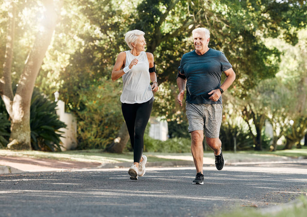 Road running, fitness and senior couple training together on a exercise and workout run. Sports and health motivation of elderly man and woman runner in retirement living a healthy lifestyle. - Photo, Image
