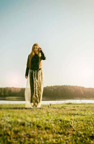 unusual gothic girl with long red hair reflects at lake - Zdjęcie, obraz