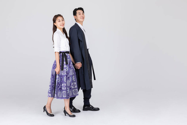 Korean young couple, man and woman wearing modern Hanbok, walking - Фото, зображення