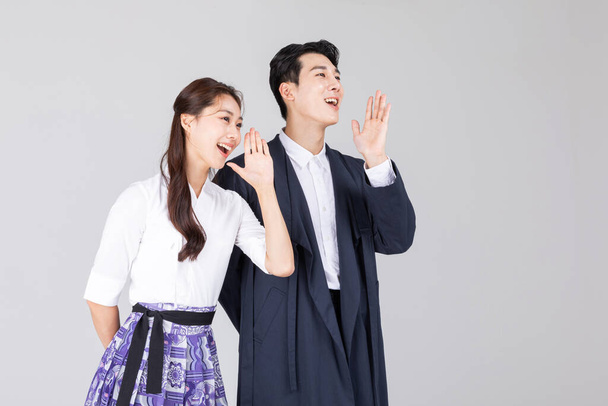 Korean young couple, man and woman wearing modern Hanbok, talking - Photo, Image