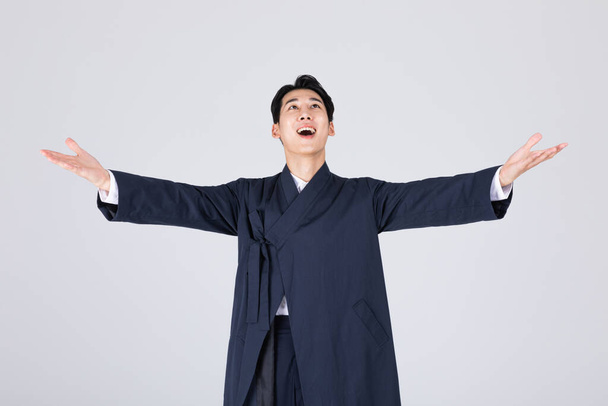 goodlooking Korean young man in 20s wearing modern Hanbok wearing hanbok, hand motion - Photo, Image