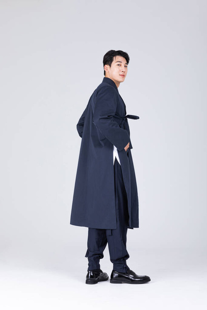 goodlooking Korean young man in 20s wearing modern Hanbok wearing hanbok, standing - Foto, Bild