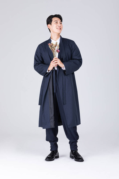 goodlooking Korean young man in 20s wearing modern Hanbok wearing hanbok, standing - Fotó, kép