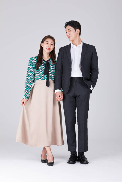Korean young couple, man and woman wearing modern Hanbok, holding hand couple - Fotografie, Obrázek