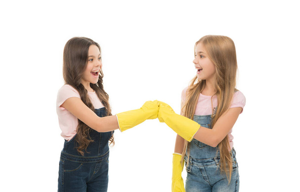 We are cleaning our house. Cleaning little ladies. Happy girls wearing yellow rubber gloves for cleaning home. Providing domestic cleaning for removing dirt and dust. - Fotografie, Obrázek