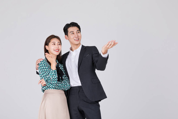 Korean young couple, man and woman wearing modern Hanbok, introducing - Zdjęcie, obraz