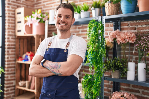 Young hispanic man florist smiling confident standing with arms crossed gesture at florist - Φωτογραφία, εικόνα