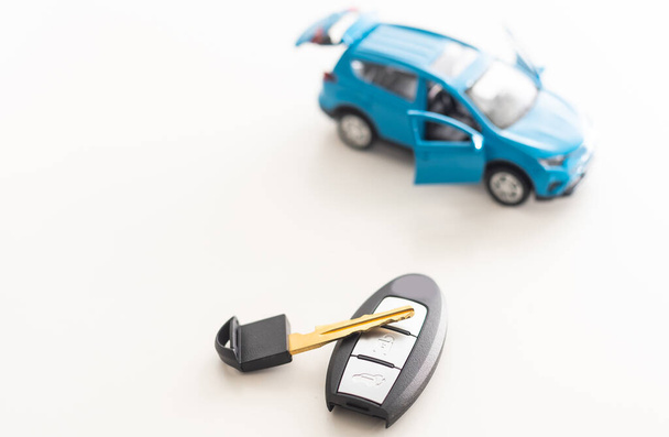 Car key and toy car. Automobile security accessories. - Photo, Image