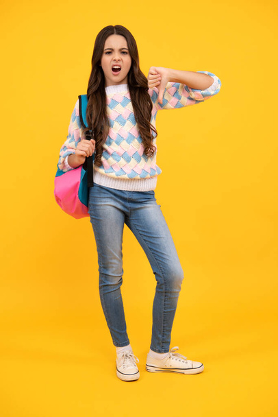 Schoolgirl with backpack. Teenager student, isolated background. Learning and knowledge. Go study. Children education concept. Back to school. Angry teenager girl, upset and unhappy negative emotion - Foto, imagen