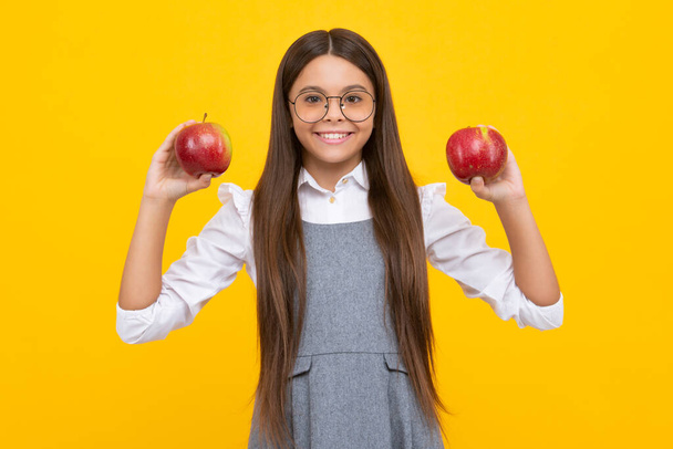 Портрет уверенной девочки-подростка с яблоком будет иметь здоровую закуску. Здоровье, питание, диета и витамины для детей. Счастливое лицо девушки, позитивные и улыбающиеся эмоции - Фото, изображение