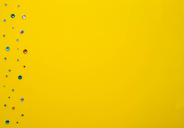 Bright yellow paper background with starz decoration on the side. Copy space for text. Flat lay, top view, copy space. Design for text - Photo, Image