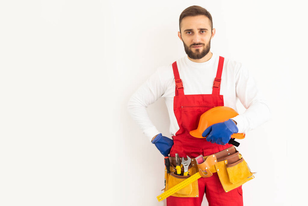 profession, construction and building - happy smiling male worker or builder over white background. - Zdjęcie, obraz