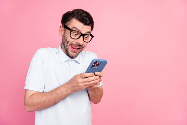 Photo of cool nice excited man hand hold telephone use device gadget write texting girlfriend empty space isolated on pink color background. - 写真・画像