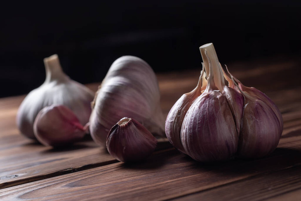 Garlic bulb on wooden background. Close up. - Фото, зображення