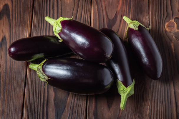 Frsh organic eggplant on the wooden boards. - Фото, изображение