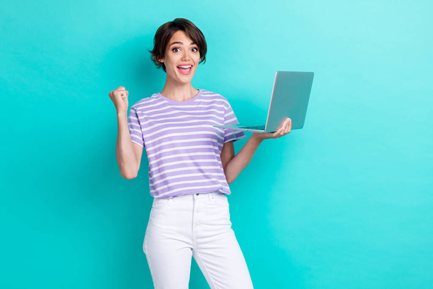 Photo of overjoyed positive lady trendy striped outfit hold netbook rejoice buy black friday sale isolated on aquamarine color background. - Photo, image