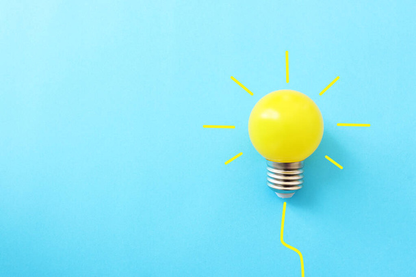 Education concept image. Creative idea and innovation. light bulb metaphor over blue background - Photo, Image