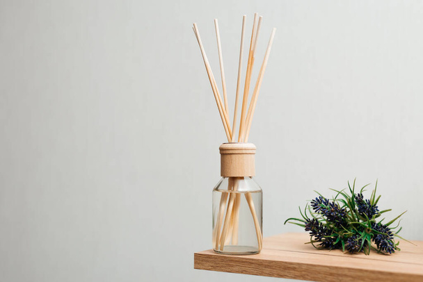 Herbal reed diffuser on white background. - 写真・画像