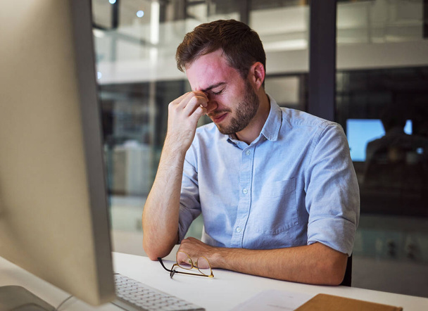 Burnout, stress and tired businessman with mental health problems struggling while working overtime in an office. Depression, headache and frustrated manager with eye strain, exhausted and overworked. - Fotoğraf, Görsel
