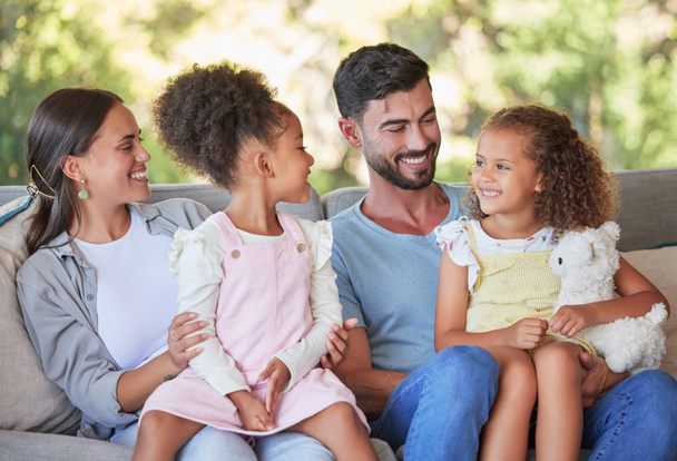 Happy family, parents and girl children on sofa bonding, love affection and care together at family home. Mom, father and young kids relax, smile and happiness sitting on lounge enjoy quality time. - Φωτογραφία, εικόνα