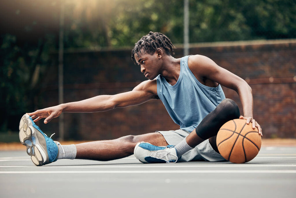 Man, basketball and training do stretching, exercise or prepare on court with sportswear. Black man, sport and ball before practice match or game in urban park for sports, fitness and physical health. - Zdjęcie, obraz