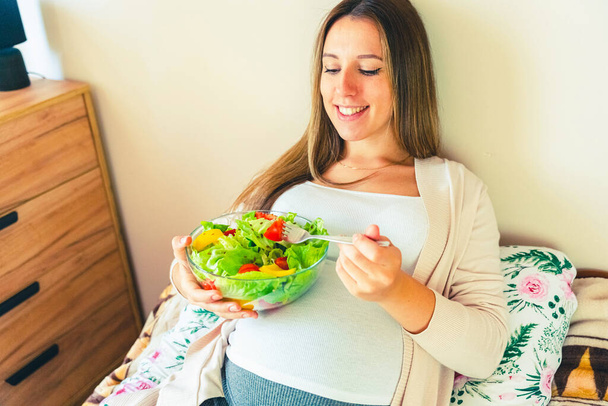 Pregnant healthy eating salad. Pregnancy woman eating nutrition healthy food. Healthy breakfast concept - Fotó, kép
