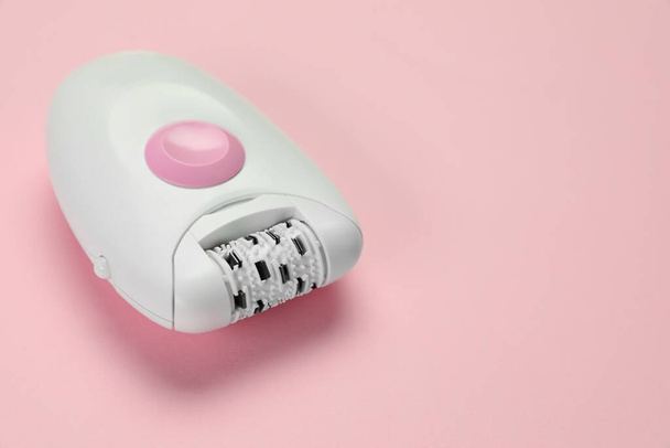 Modern epilator on pink background, closeup. Space for text - Фото, изображение