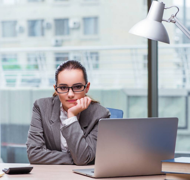 The businesswoman sitting at her desk in business concept - Photo, Image