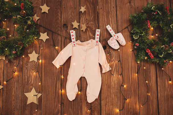 Baby clothes on the clothesline Christmas decorated - Fotoğraf, Görsel