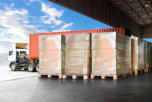 Packaging Boxes Wrapped Plastic Stacked on Pallets Loading into Cargo Container. Shipping Trucks. Supply Chain Shipment. Distribution Supplies Warehouse. Freight Truck Transport Logistics. - Photo, Image