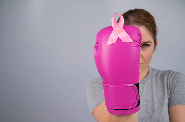 Woman doctor in pink boxing gloves on a white background - Foto, Imagem