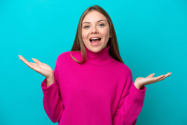 Young Lithuanian woman isolated on blue background with shocked facial expression - Photo, Image