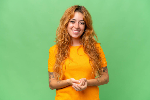 Young caucasian woman isolated on green screen chroma key background laughing - Foto, afbeelding