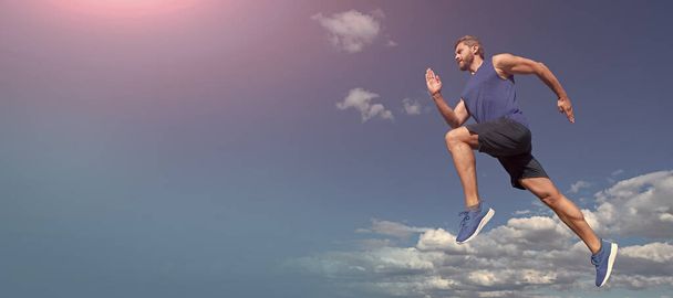 Man running and jumping, banner with copy space. workout activity. healthy man jumping. fitness guy in sportswear. full of energy - Photo, Image