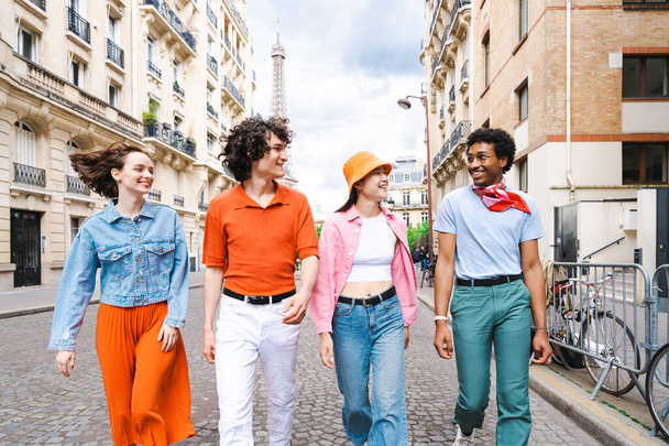 Group of young happy friends visiting Paris and Eiffel Tower, Trocadero area and Seine river - Multicultural group of tourists sightseeing the France capital city - Photo, image
