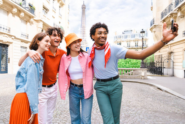 Group of young happy friends visiting Paris and Eiffel Tower, Trocadero area and Seine river - Multicultural group of tourists sightseeing the France capital city - Фото, изображение