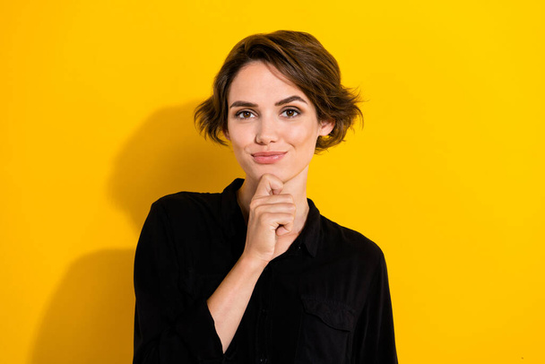 Photo of thinking millennial short hair lady wear black shirt isolated on yellow color background. - Фото, зображення