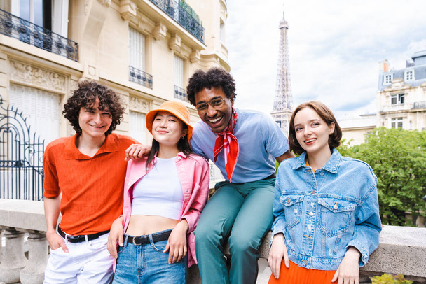 Group of young happy friends visiting Paris and Eiffel Tower, Trocadero area and Seine river - Multicultural group of tourists sightseeing the France capital city - Фото, изображение