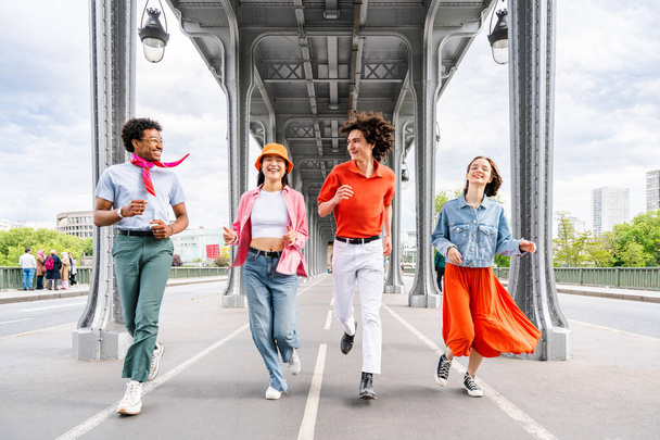 Group of young happy friends visiting Paris and Eiffel Tower, Trocadero area and Seine river - Multicultural group of tourists sightseeing the France capital city - 写真・画像