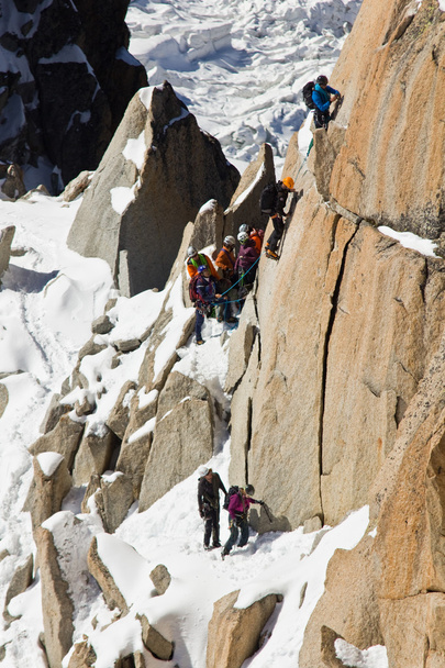 Alpine climbers climbing on a rock in the Mont Blanc massif - Fotó, kép