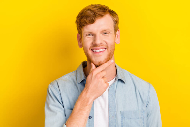 Photo portrait of nice young man touch chin smile create business strategy dressed trendy denim clothes isolated on yellow color background. - Foto, Imagem