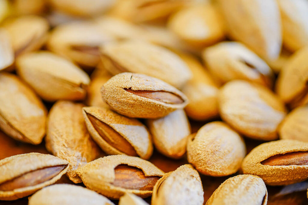 Close up a pile of almonds on the indoor table - 写真・画像
