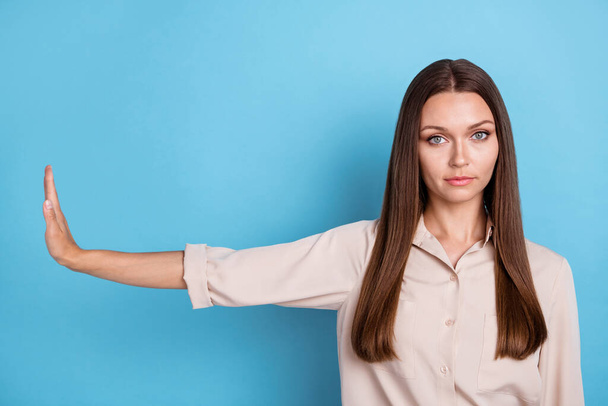 Photo of nice upset young girl stretch hand showing aside decline gesture wear stylish smart casual look isolated on blue color background. - 写真・画像