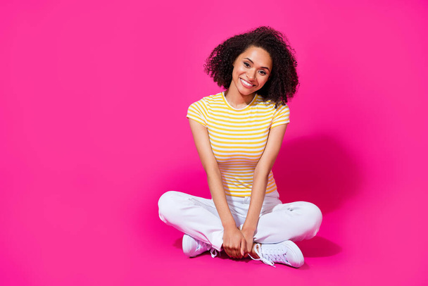 Full body size photo of young adorable pretty cute girl sitting crossed legs toothy smile sitting relax isolated on pink color background. - Fotografie, Obrázek